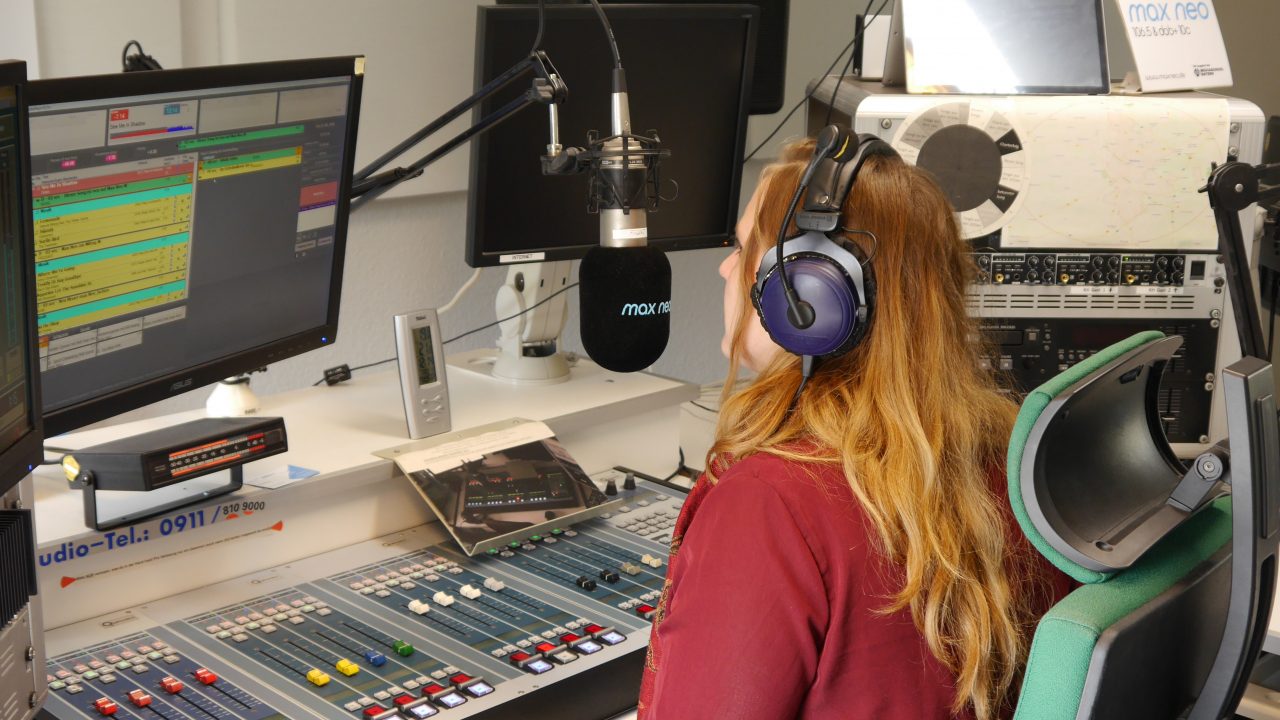 Chefin vom Dienst Pauli sitzt am Mischpult im Sendestudio von max neo