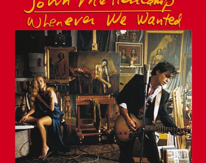 Das Albumcover "Whenever We Wanted" von John Mellencamp zeigt den Musiker in einem Set, wie er Gitarre spielt. Im Hintergrund ist eine blonde Frau zu sehen.