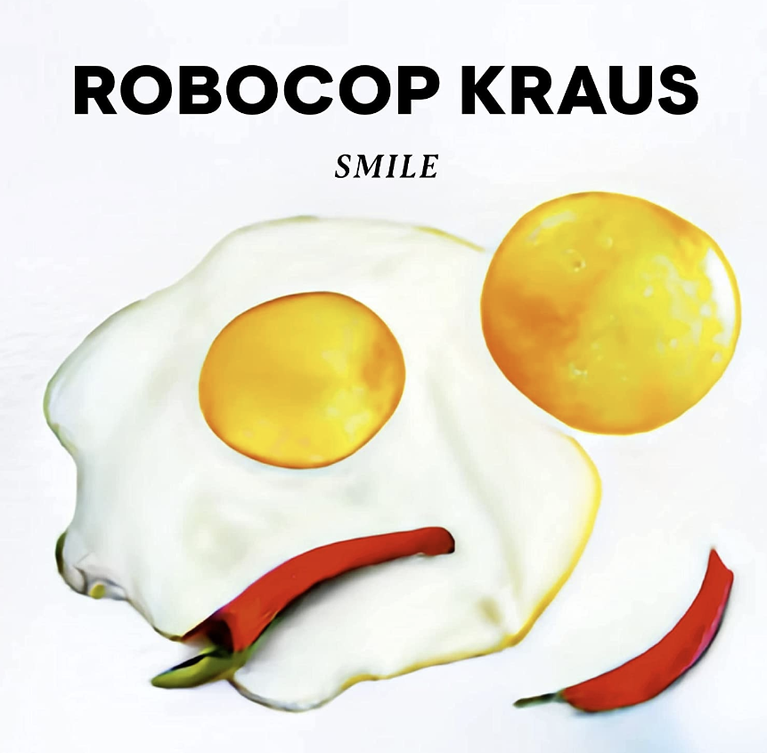 Das Albumcover "Smile" von Robocop Kraus zeigt ein Spiegelei, einen gelben Kreis und rote Pepperonis. Die Lebensmittel liegen so da, dass sie wie ein lächelndes Gesicht aussehen.