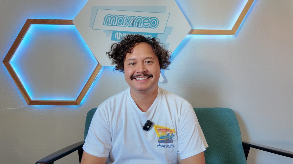 Das Foto zeigt den Musiker Chris Padera vor dem max neo Logo.